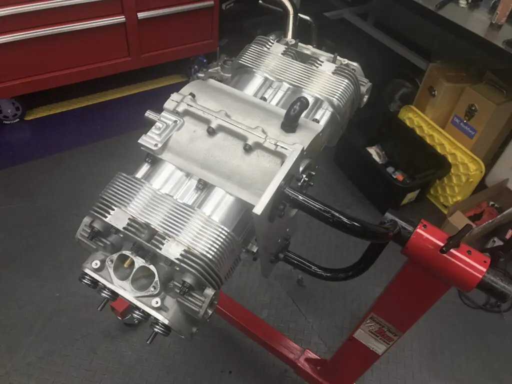 Close-up of a silver engine block on a workbench.