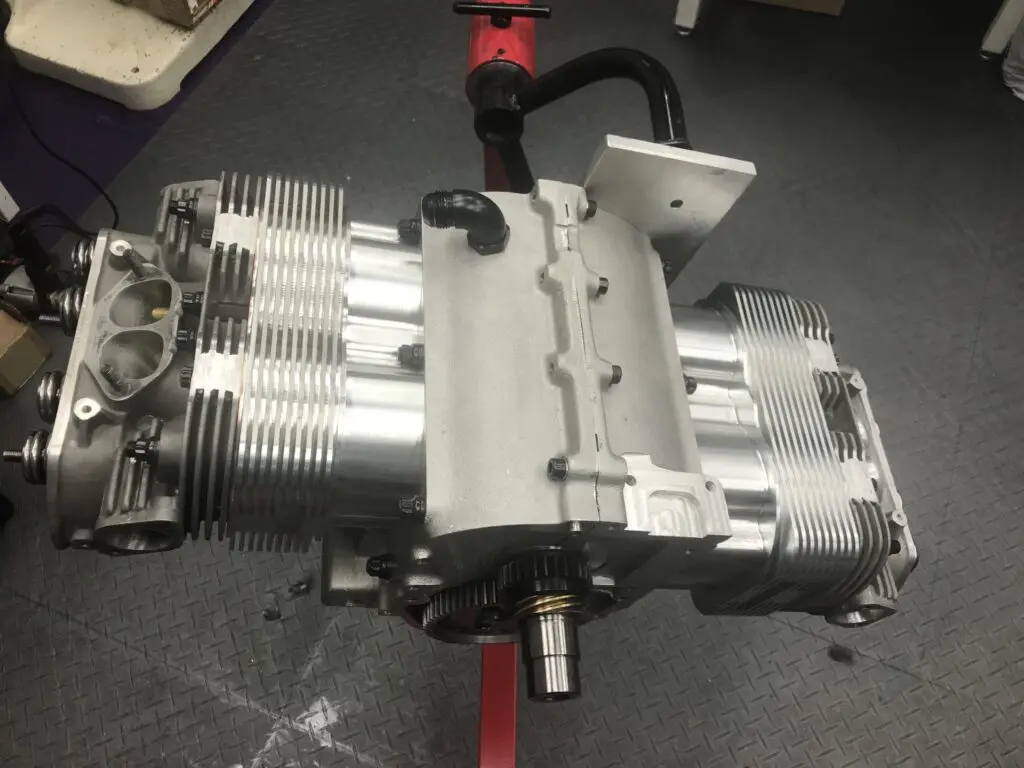 Close-up of a mechanical engine component on a workbench.