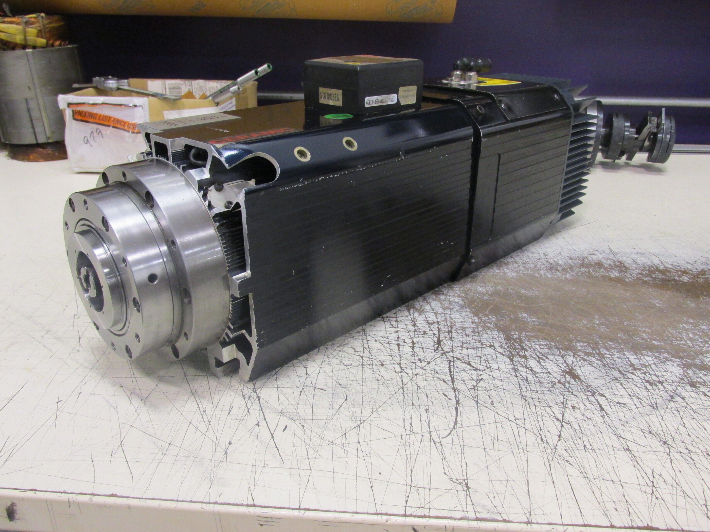 A partially disassembled electric motor on a workbench.