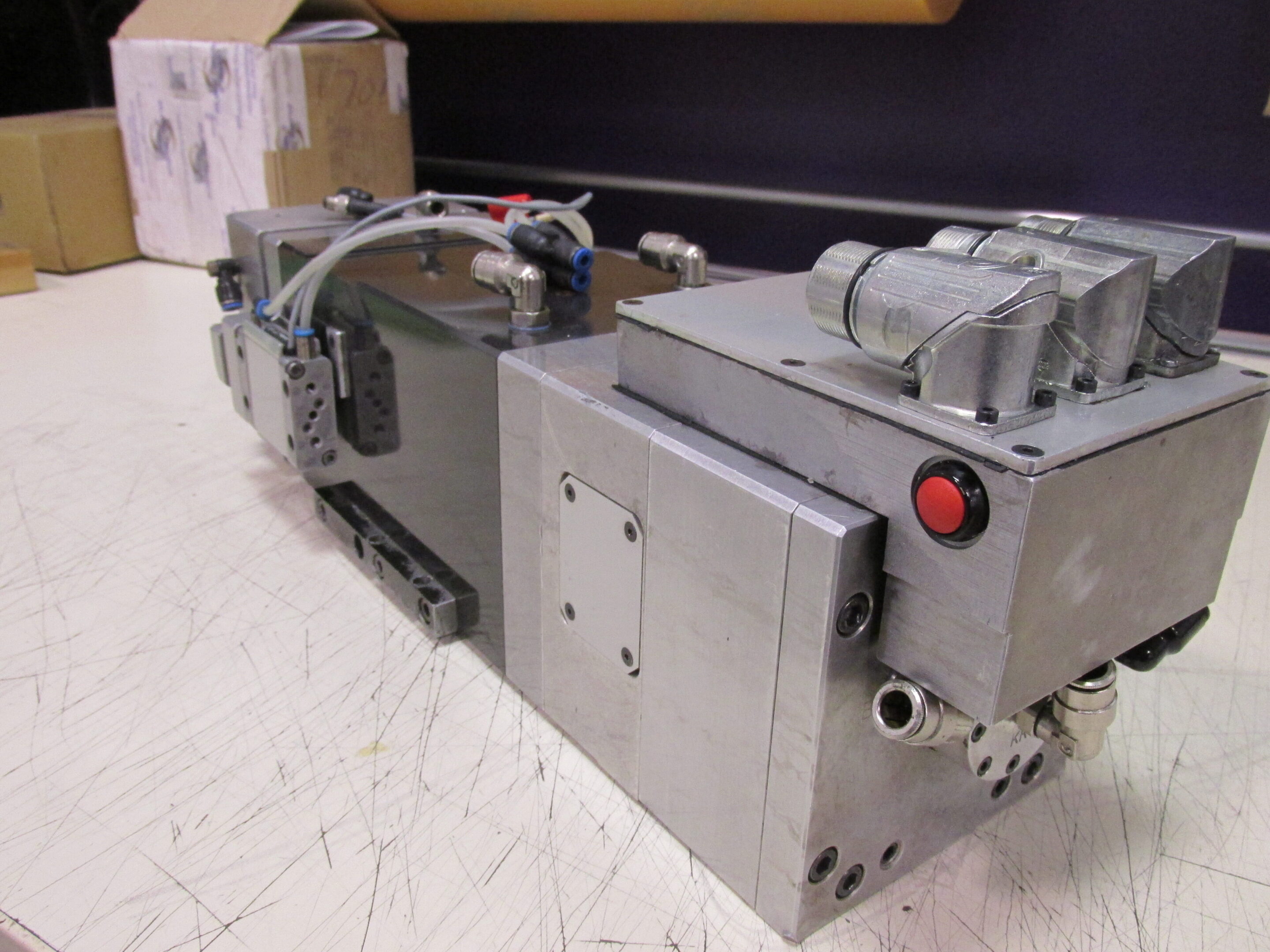 Industrial machinery with metallic components and wiring on a workbench.