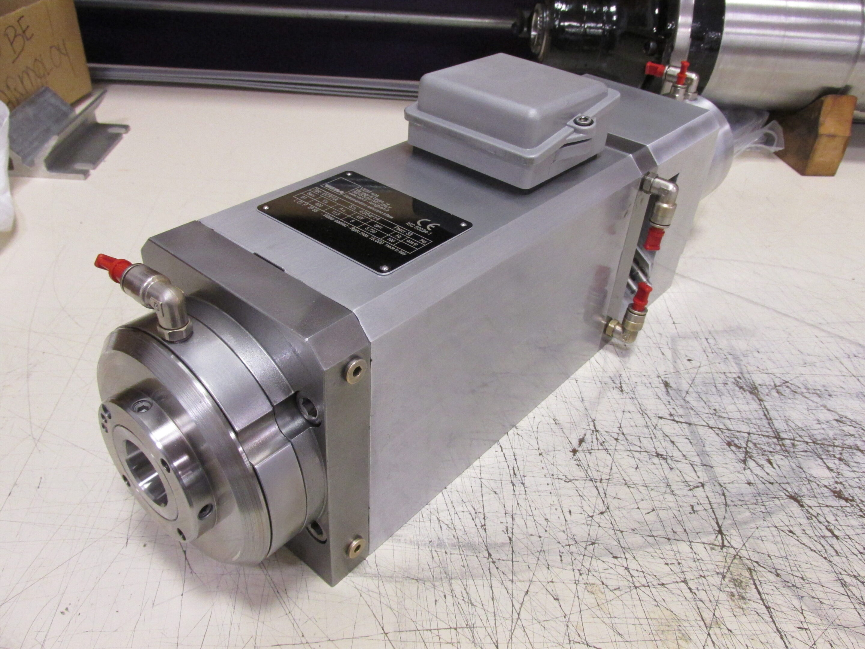 A compact industrial servo motor with attached encoder and wiring connections.