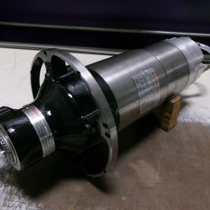 Close-up of a metal cylindrical industrial component on a workshop floor.